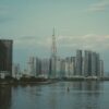 Skyline view of Ho Chi Minh City featuring Landmark 81 Tower and adjacent riverfront.