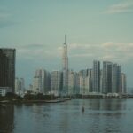 Skyline view of Ho Chi Minh City featuring Landmark 81 Tower and adjacent riverfront.