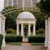 Beautiful white gazebo with pillars in a lush Malaysian garden. Perfect for serene moments.