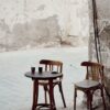 Cozy outdoor cafe setting with empty chairs in Jeddah, Saudi Arabia's historic district.