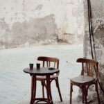 Cozy outdoor cafe setting with empty chairs in Jeddah, Saudi Arabia's historic district.