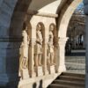 Stone statues at Fisherman's Bastion in Budapest, captured in early morning light, showcasing arches and shadow play.