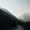 Captivating view of Ticino's mountainous landscape with sunlight streaming through the peaks.