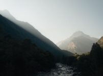 Captivating view of Ticino's mountainous landscape with sunlight streaming through the peaks.