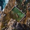 Aerial view of a rock pool on a rugged coastline.