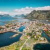 Picturesque coastal town nestled among islands and mountains.