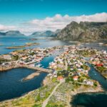 Picturesque coastal town nestled among islands and mountains.