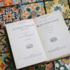 Vintage italian book open on a vibrant tiled table
