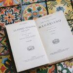 Vintage italian book open on a vibrant tiled table